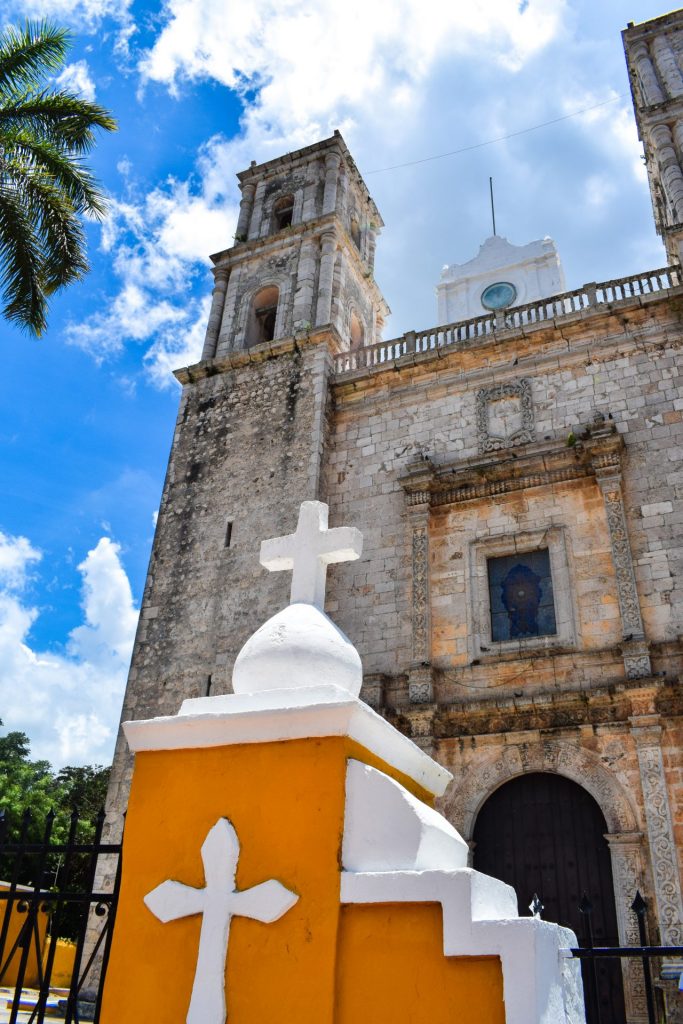 Church in Mexico with yellow and white painted crosses on the gate.