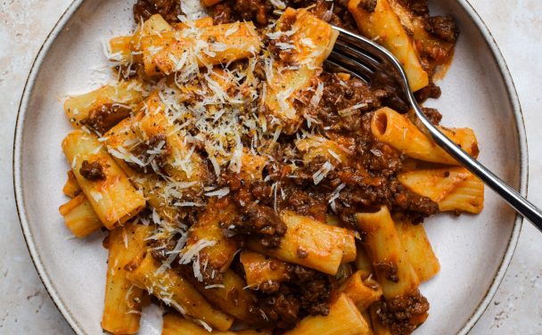 Venison Ragù tossed with rigatoni on a stone plate.